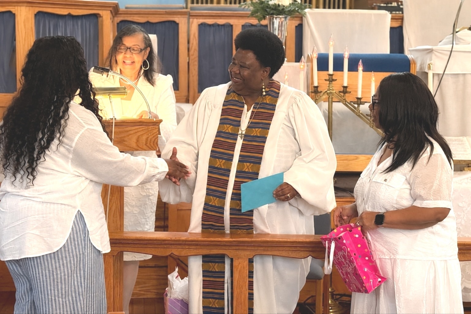 Pastor Bell greeting a new member at the altar of Zion AME Church
